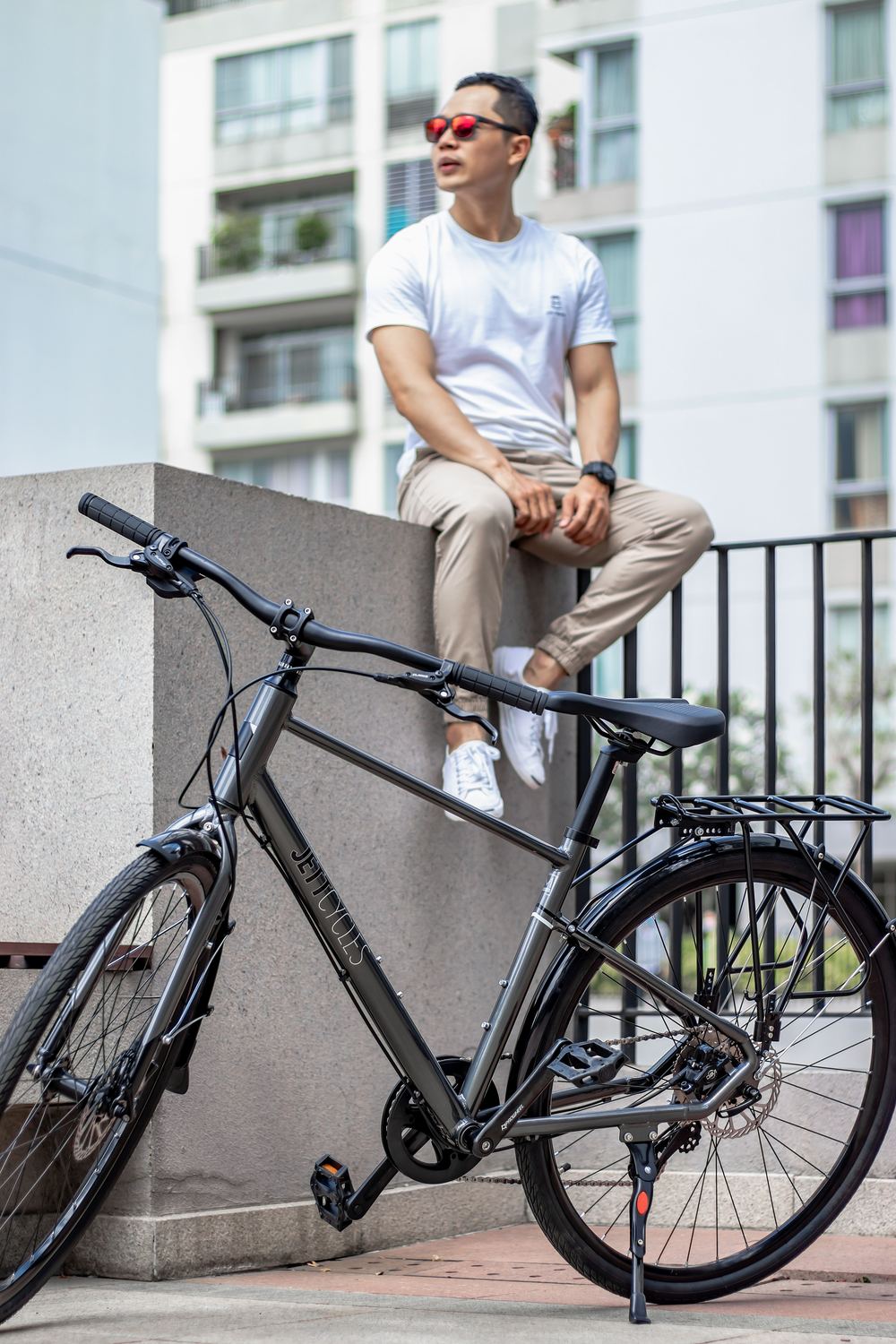 Man resting beside his bike in the city