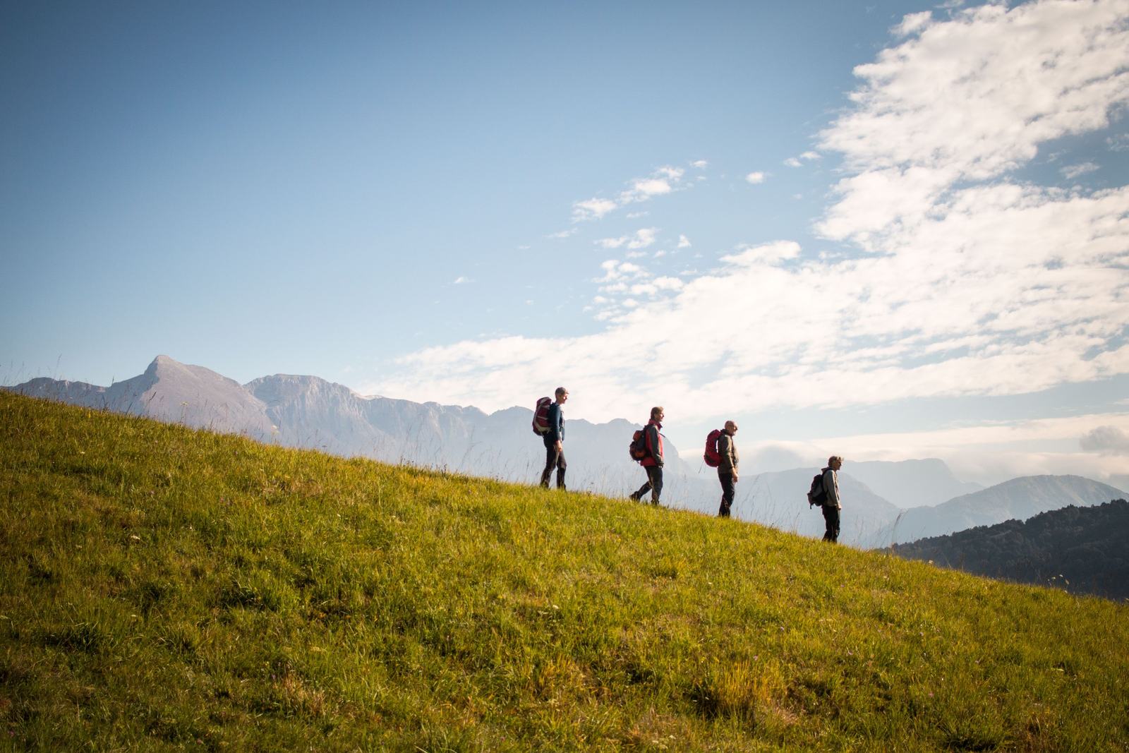 Group of hikers walking a mountain ridge