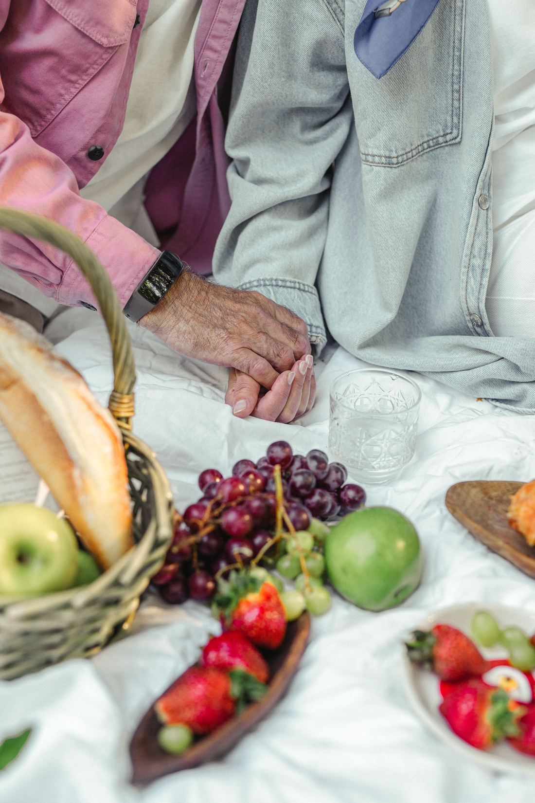 Couple sharing a picnic of fruit and bread