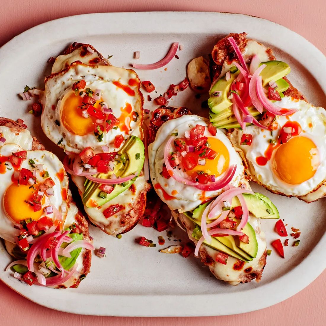 Fried eggs with avocado and pico de gallo on toasted bread